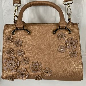 Charming Charlie’s rose gold purse/crossbody. Has flowers on front.